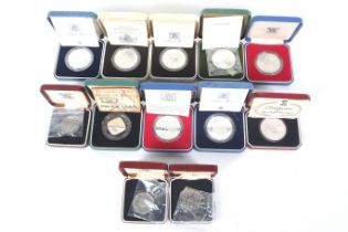 A collection of assorted proof coins. Including seven silver proof crowns.