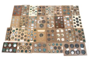 A collection of 19th and 20th century world coins. All in wooden coin trays.