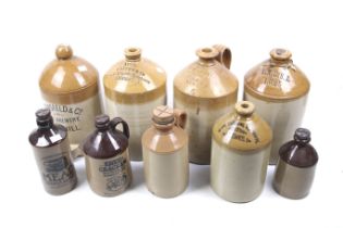 A collection of vintage saltglazed stoneware bottles. Including four cider flagons, one marked 'J.
