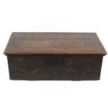 An antique carved oak chest.