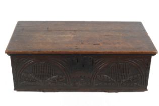 An antique carved oak chest.