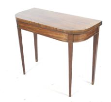 A Victorian 'D-shape' mahogany card table.