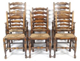 A set of six 20th century stained ash ladderback rush seat chairs.