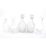 A collection of assorted glass decanters.