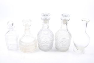 A collection of assorted glass decanters.