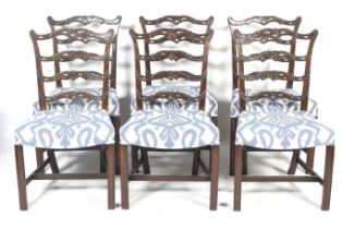 A set of six 19th century mahogany wavy ladder back dining chairs.