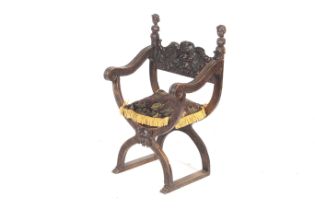 An 18th/19th century carved walnut X frame open arm chair.