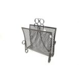 A mid century wrought metal magazine rack.