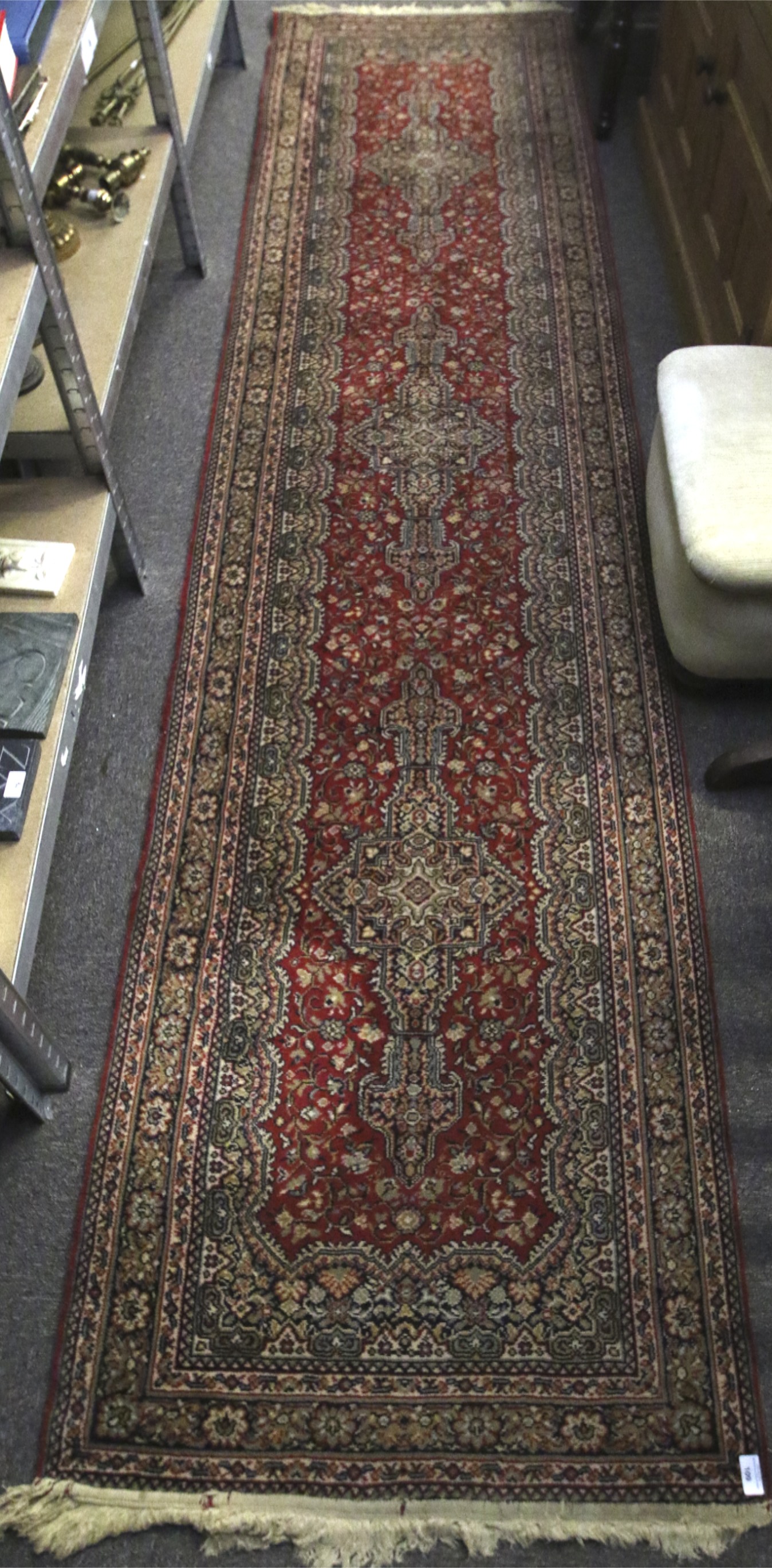 A Persian style woollen carpet runner.