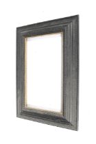 A large ebonized and gilt carved wood picture frame.