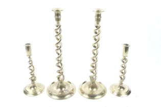 Two pairs of 20th century brass open twist candlesticks. On round bases.