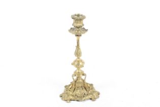 A 19th century elaborate gilt metal candlestick.