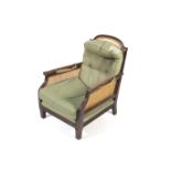 A early 20th century bergere armchair.