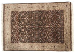 A brown ground rug with cream decoration.