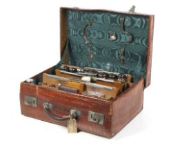 An early 20th century gentleman's alligator skin travelling suitcase.