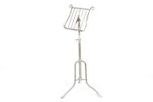 A vintage brass music stand. Of adjustable height, on tripod base,