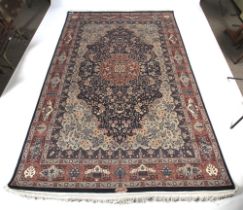 A Persian blue ground wool rug with red and cream details.