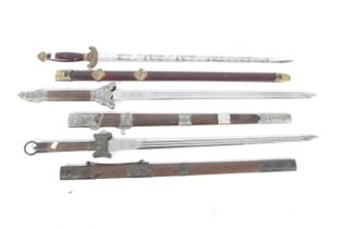 Three modern 'ancient' Chinese replica straight swords. Each with its scabbard.
