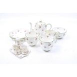 A Crown Staffordshire tea service for two and a miniature dolls house tea set.