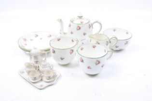 A Crown Staffordshire tea service for two and a miniature dolls house tea set.