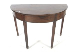 A 19th century demi lune shaped mahogany side hall table.
