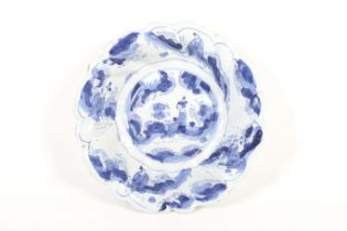 A rare Bristol Delft blue and white deep dish of spiral lobed form and figures in a landscape,