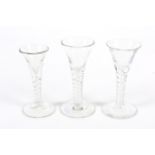 A collection of pedestal air twist glasses.