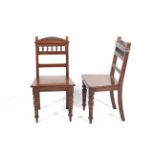 A pair of late Victorian walnut hall chairs.