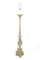 A carved gilt wood standard lamp.