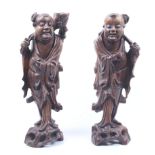 A pair of Chinese carved hardwood figures.
