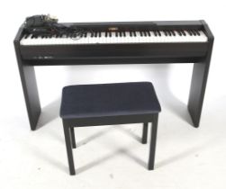 Kawai Digital piano keyboard and stool.