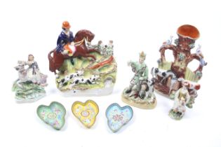 A collection of 19th century Staffordshire figures and three enamel dishes.
