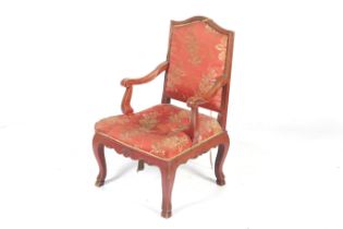 A Chinese style red stained open armchair. With red satin upholstery.