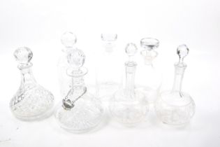 Seven assorted decanters. Including a pair Victorian etched and two cut glass crystal ship's, etc.