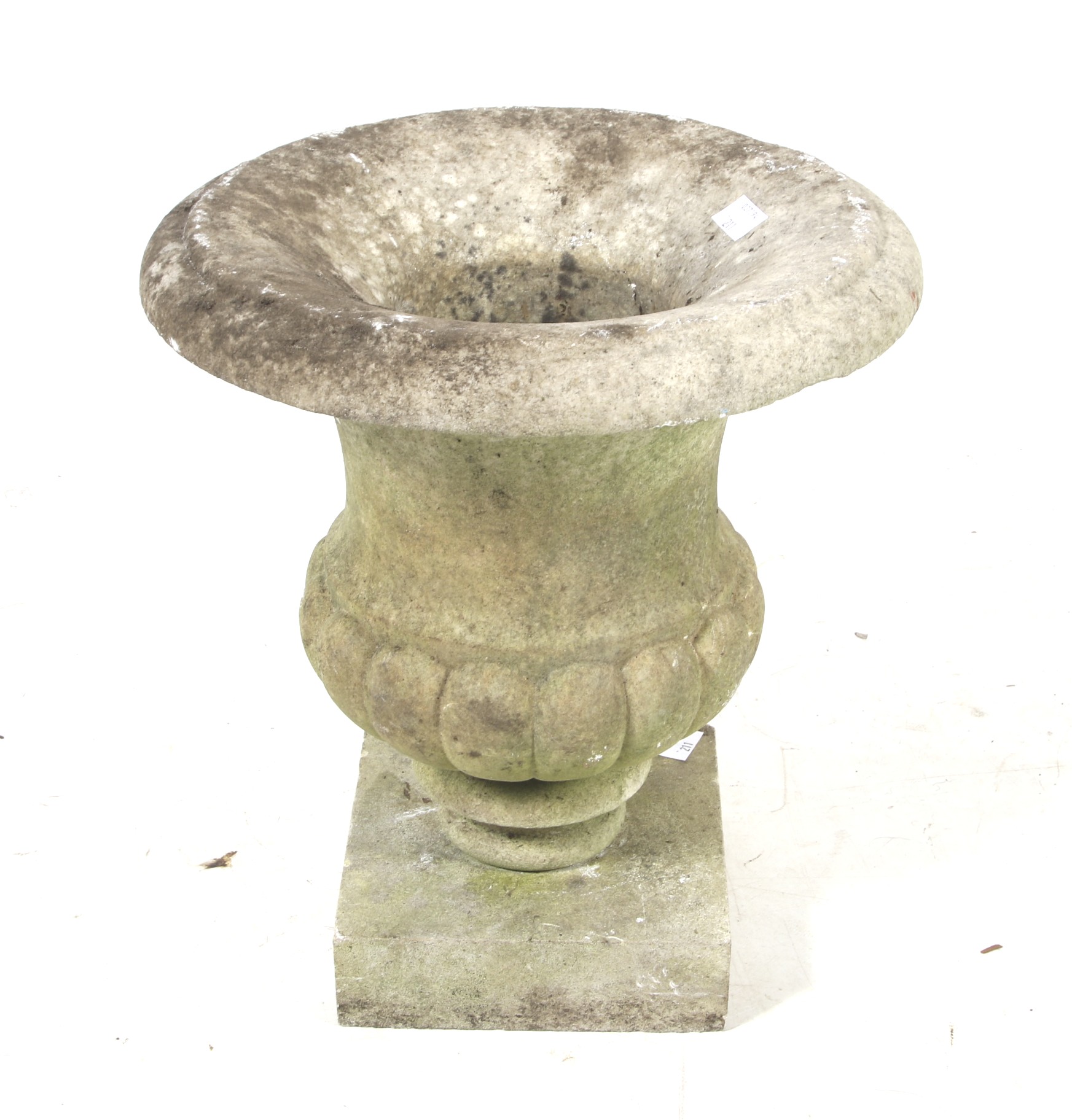 A 19th century carved stone garden urn. Mounted on a later square plinth.