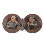 A pair of Austrian terracotta wall plaques.