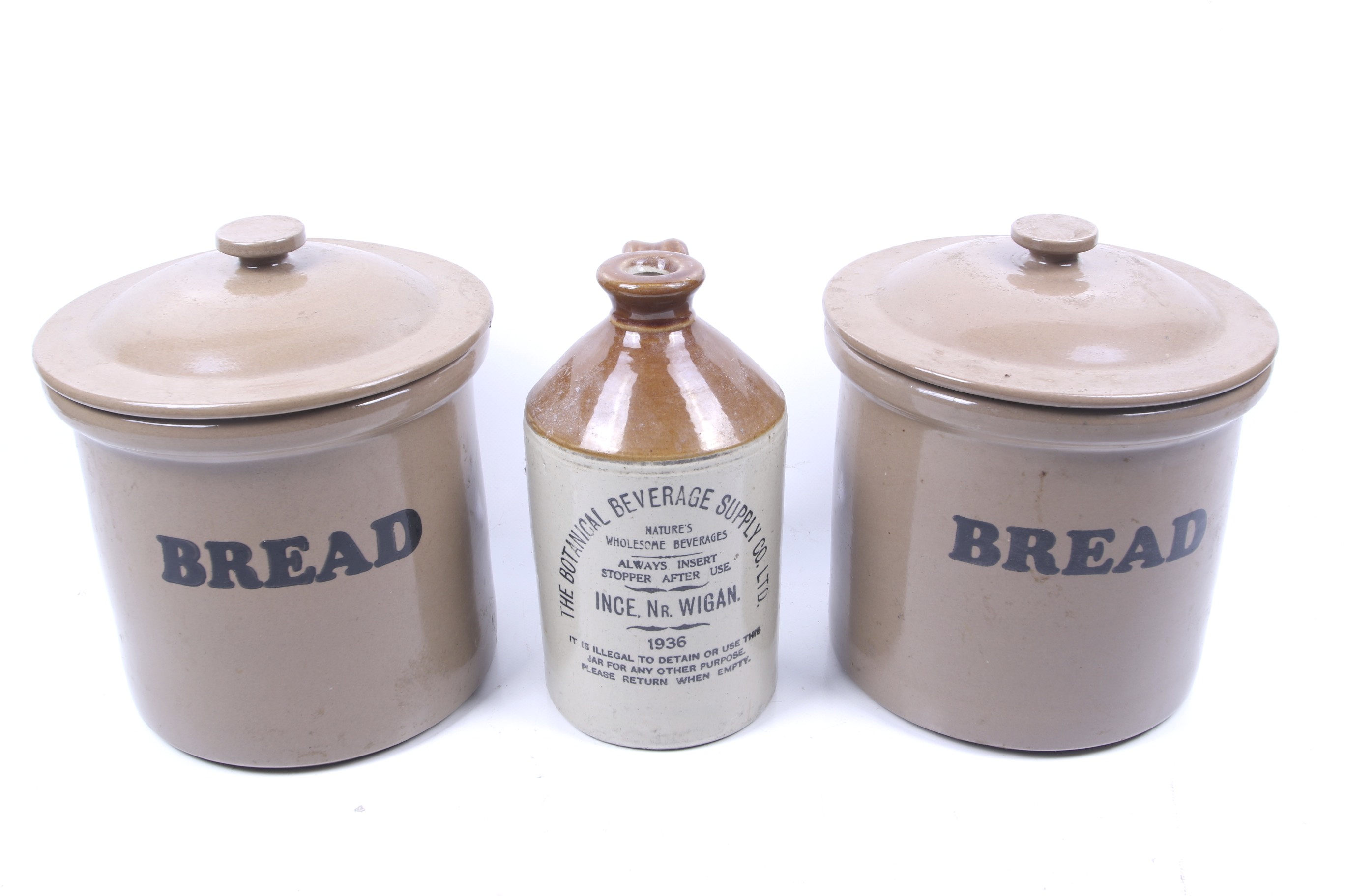 Two stoneware lidded jars and a flagon.