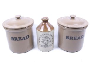 Two stoneware lidded jars and a flagon.