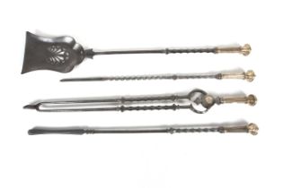 A set of four Georgian steel and brass fire irons.