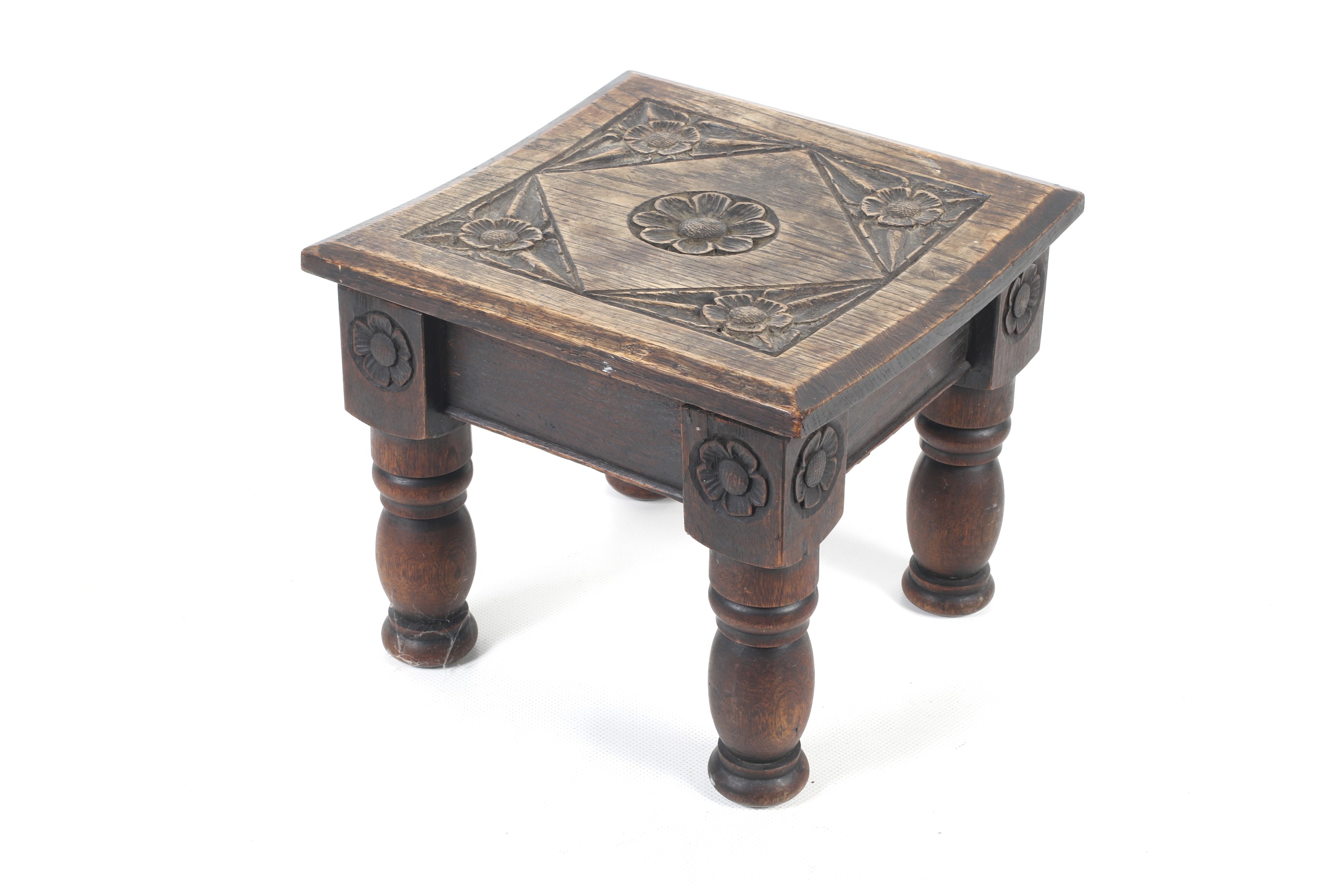 A 19th century carved oak stool from Street Church, Somerset.