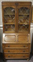 An early 20th century oak glazed bureau bookcase.