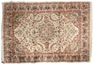A 20th century rug. Cream ground rug with red decoration.