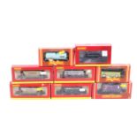 Eight Hornby OO gauge goods wagons. Including tankers, bulkers and flatbeds, all in original boxes.