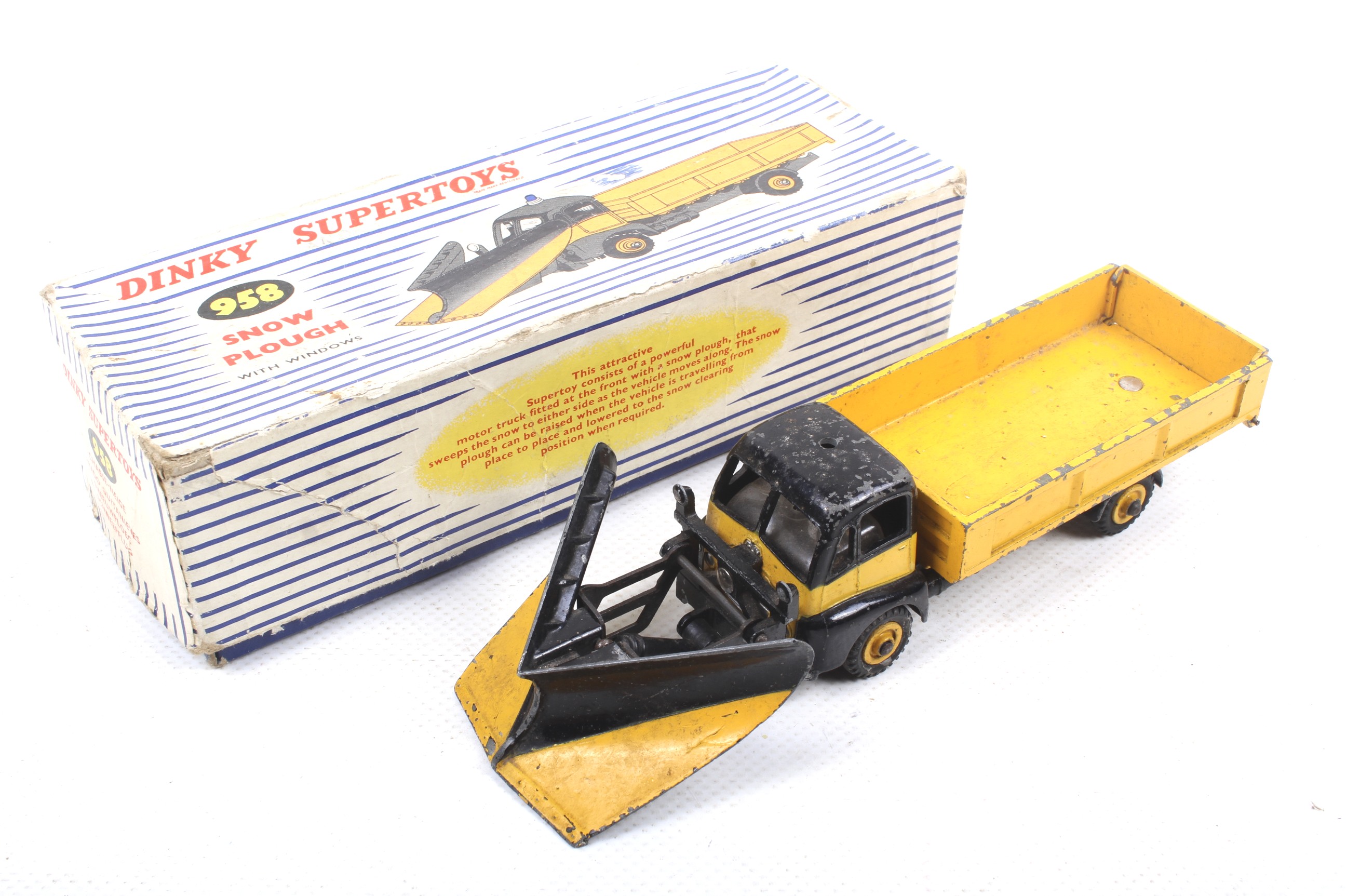 A Dinky diecast Snow Plough. No. 958, black and yellow body, in original box.