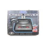 A Sega Mega Drive 2 video game console plus games.