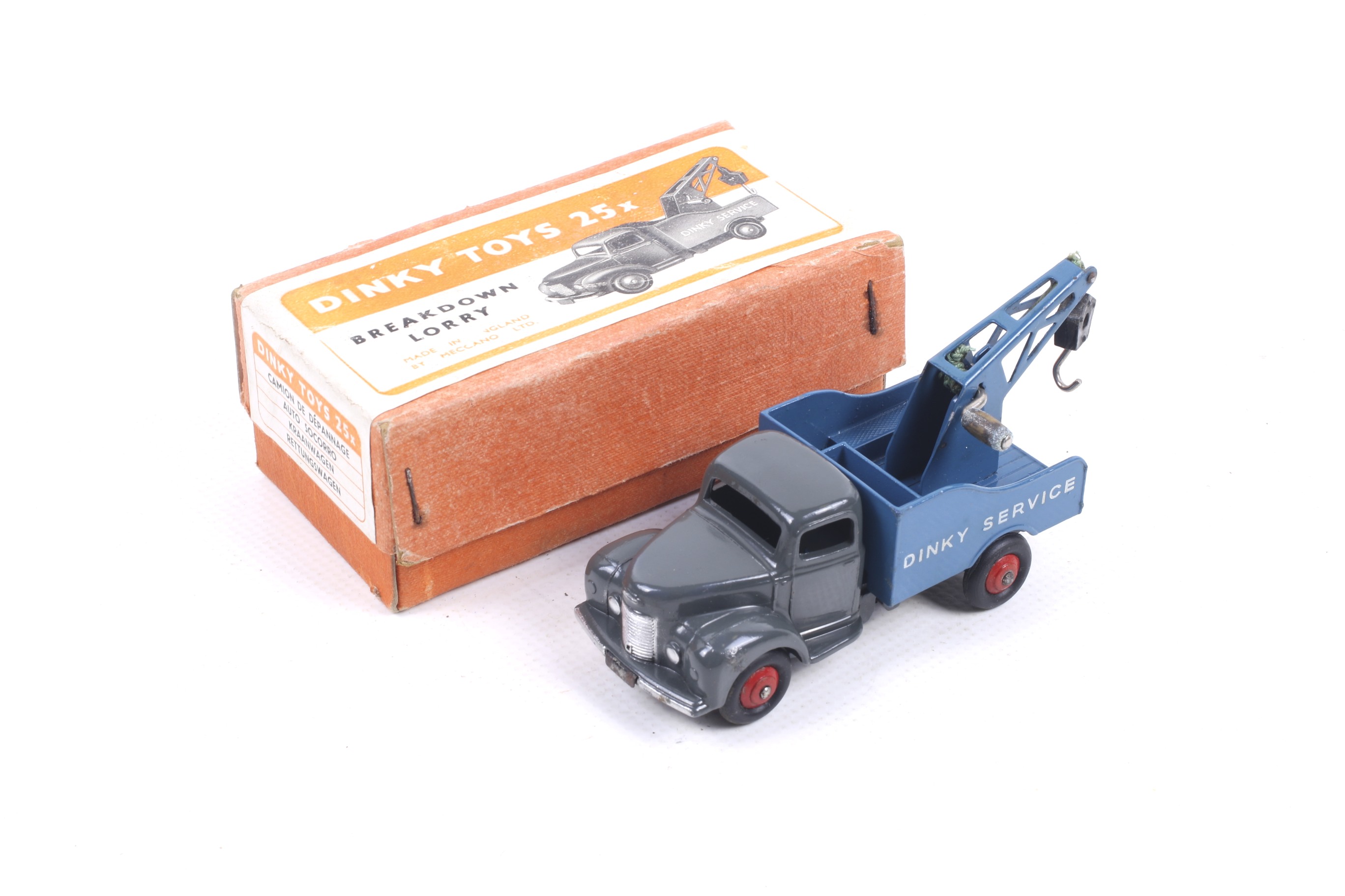 A Dinky diecast breakdown lorry. No. 25X with grey body and blue bed, in original box.