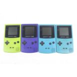 Four Nintendo Game Boy Colour handheld game consoles.