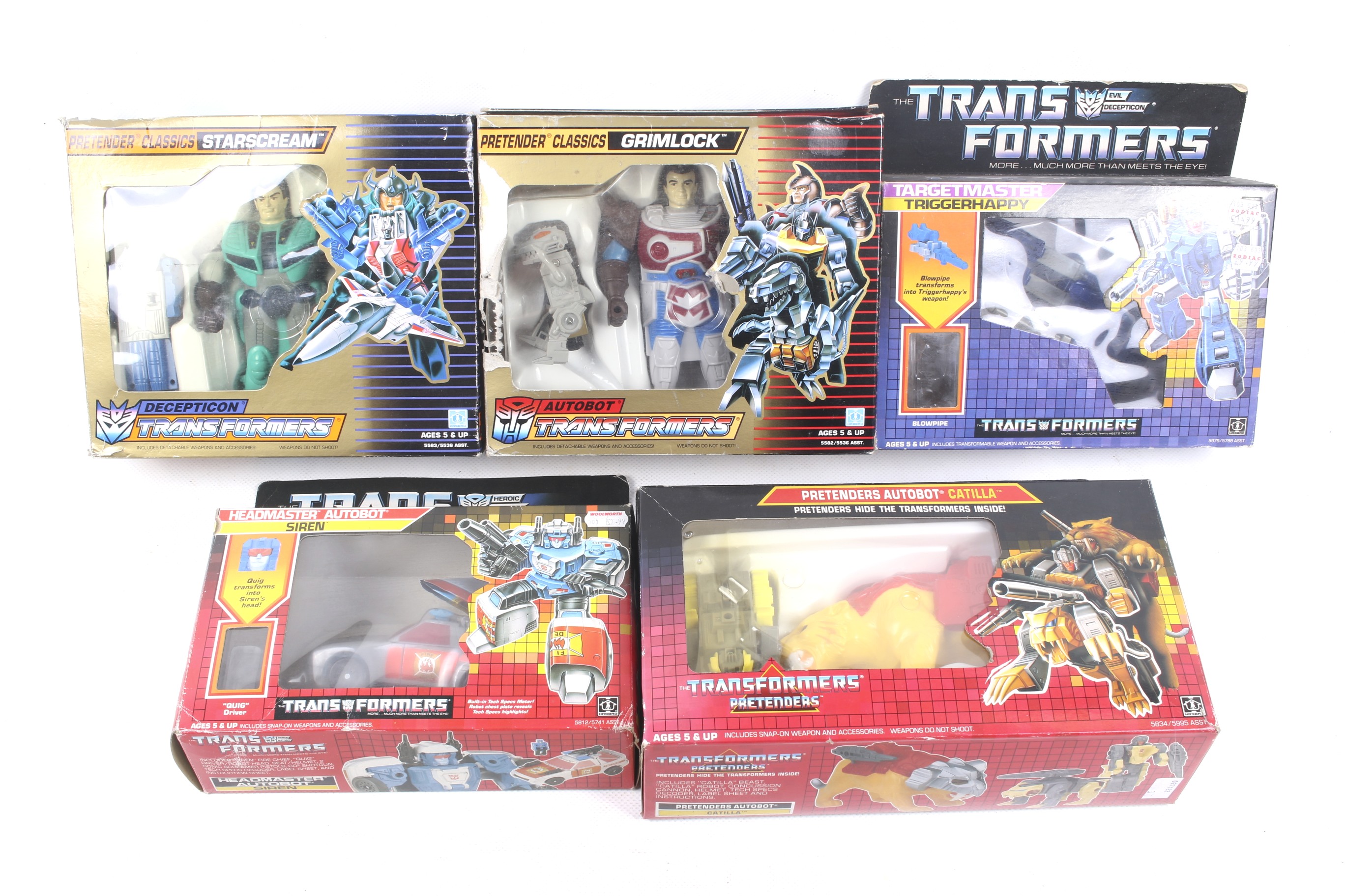 A collection of five assorted vintage 1980s Transformer toys boxed.