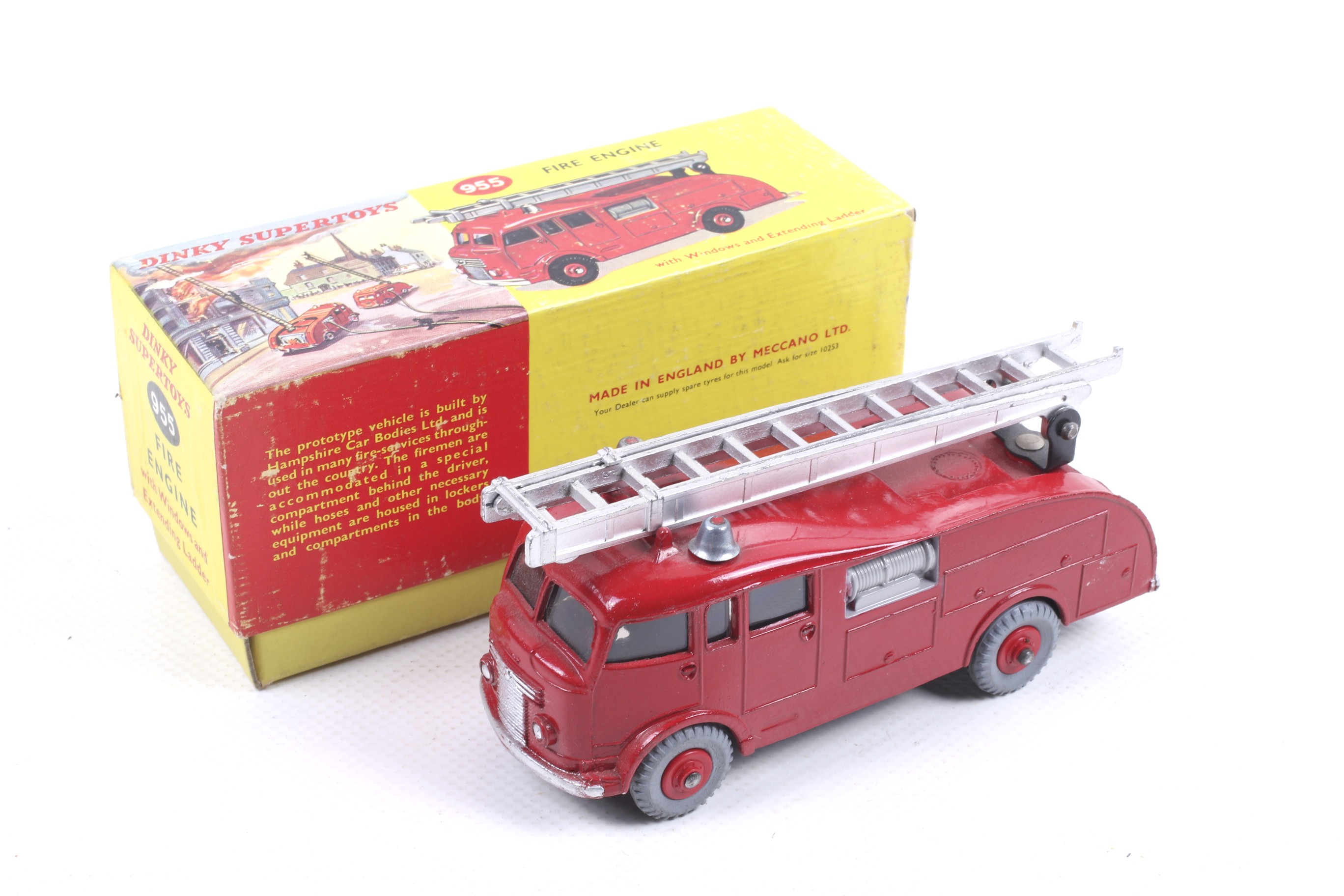 A Dinky diecast Fire Engine. No. 955, red body with chrome trim and ladder, in original box.