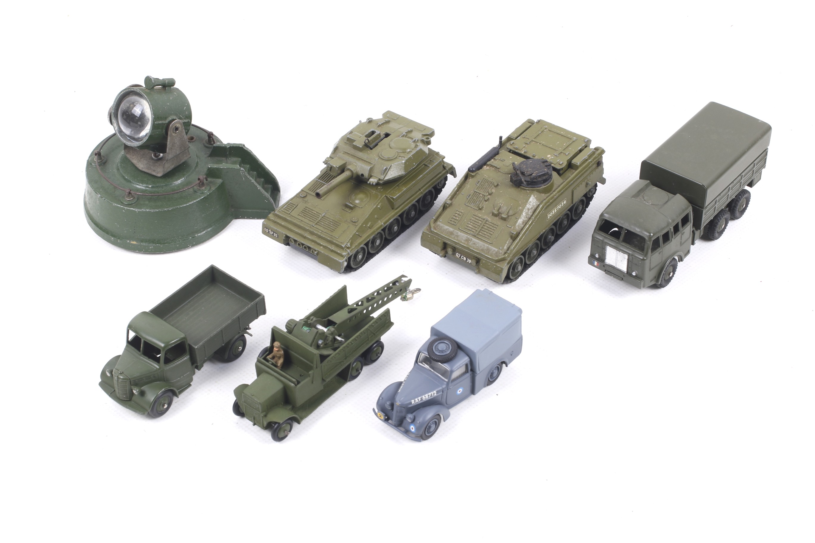 Eight Dinky diecast military vehicles. Including tanks, trucks and a searchlight etc, all unboxed.